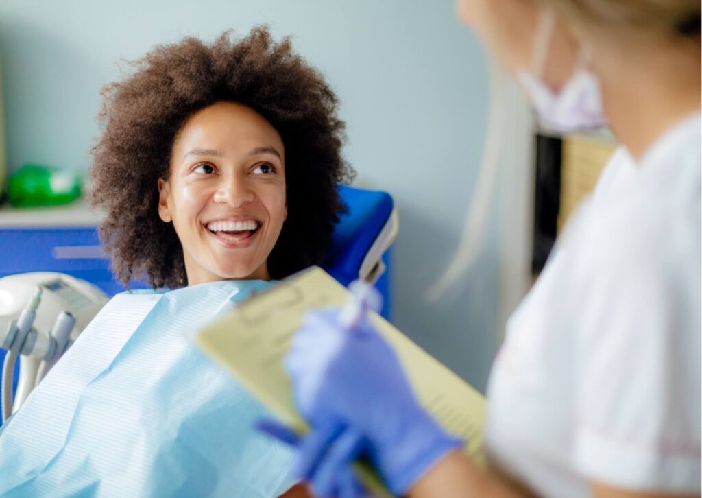 Patient consulting with a dentist about veneers, highlighting factors that influence veneers lifespan and long-term care.