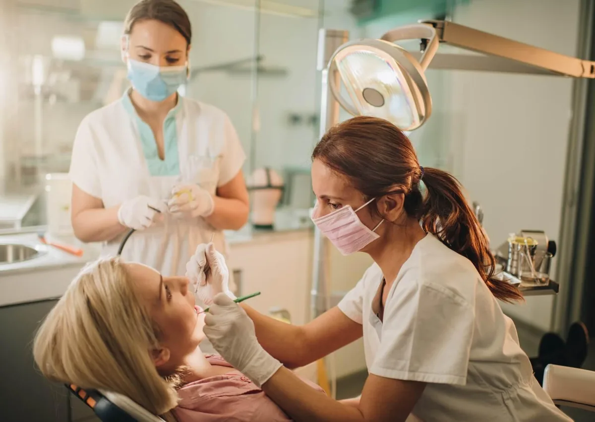 Dentist examining a patient’s teeth as part of preventive dental care to help detect and prevent cavities.