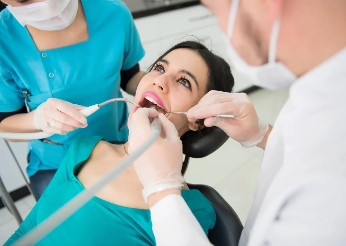 Dental team providing preventive dental care with a professional teeth cleaning and oral examination.